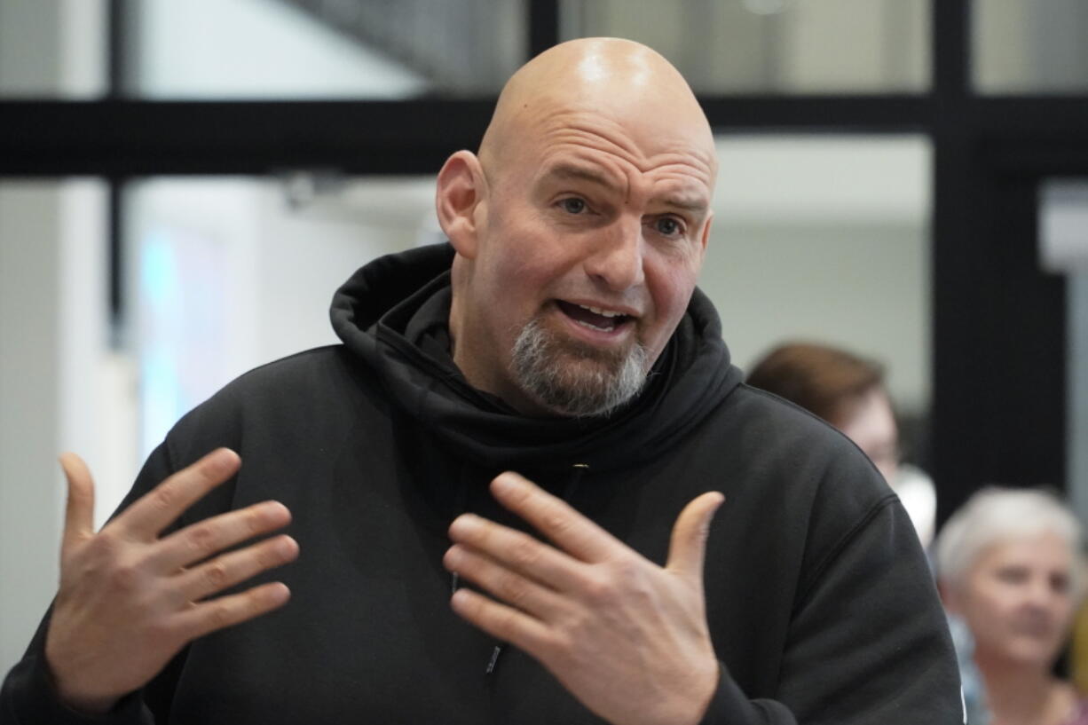 FILE - Pennsylvania Lt. Gov. John Fetterman visits with people attending a Democratic Party event for candidates to meet and collect signatures for ballot petitions for the upcoming Pennsylvania primary election, at the Steamfitters Technology Center in Harmony, Pa., March 4, 2022. The fate of the Democratic Party is intertwined in a pair of Pennsylvania elections that'll be closely watched this year. John Fetterman could help the party keep control of the Senate.