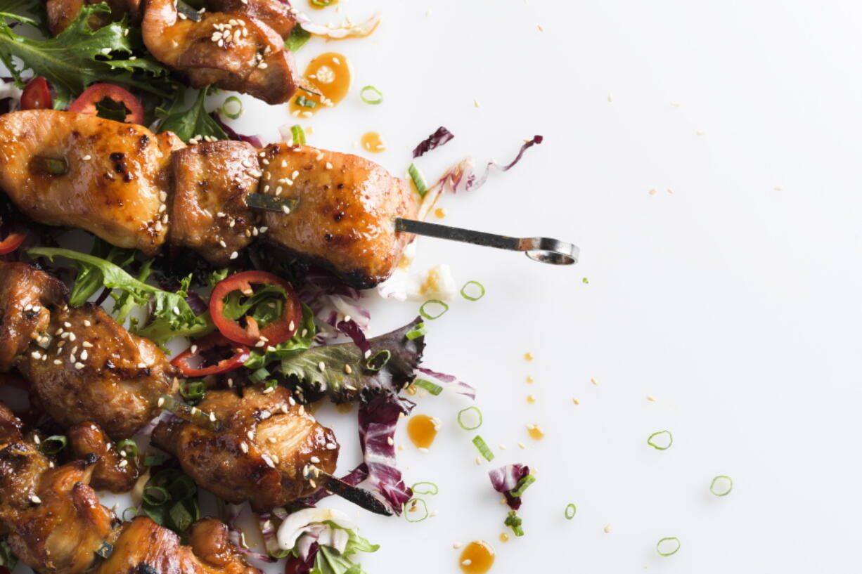 This image released by Milk Street shows a recipe for Maple and Soy-Glazed Chicken Skewers.