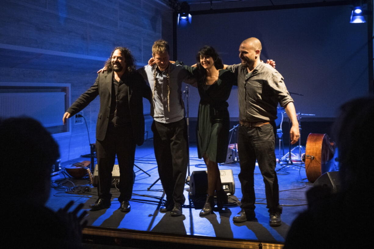 Wassim Mukdag, Borys Slowikowski, Eden Cami and Or Rozenfeld of Arab-Israeli-Jewish band Kayan Project acknowledge the applause of the audience during a concert at the Jewish theatre boat 'MS Goldberg' in Berlin, Sunday, May 29, 2022. The Berlin band Kayan Project, with a diverse cast of musicians from across the Middle East, might never been able to perform together in the members' home countries. But it has risen to local fame in Berlin, Germany, with its unique style that combines oriental tunes with both Arabic and Hebrew lyrics. The band members include an Arab-Druze singer from northern Israel, a Syrian refugee and a Jewish Israeli bassist.