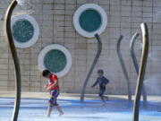 Children play at a water park, Monday, June 13, 2022, in Miami Beach, Fla. More than 100 million Americans are being warned to stay indoors if possible as high temperatures and humidity settle in over states stretching through parts of the Gulf Coast to the Great Lakes and east to the Carolinas.