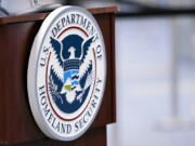 FILE - A U.S. Department of Homeland Security plaque is displayed a podium as international passengers arrive at Miami international Airport where they are screened by U.S. Customs and Border Protection, Nov. 20, 2020, in Miami. Employees accused of misconduct at the Department of Homeland Security could face more stringent penalties under an overhaul announced Thursday that follows complaints about the handling of internal discipline in the third largest U.S. government agency.