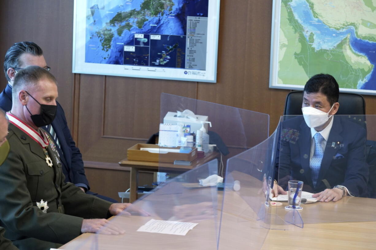 Commander of the U.S. Pacific Marine Corps, Lt. Gen. Steven Rudder, left, meets with Japanese Defense Minister Nobuo Kishi, right, during a courtesy call at the Defense Ministry Friday, June 17, 2022, in Tokyo.