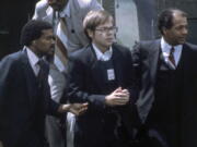 FILE - U.S. Marshals escort John Hinckley Jr. as he returns to a marine base via helicopter in Quantico, Va., Aug. 8, 1981. Hinckley, who shot and wounded President Ronald Reagan in 1981, was freed from court oversight Wednesday, June 15, 2022, officially concluding decades of supervision by legal and mental health professionals.