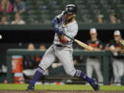 Seattle Mariners' Abraham Toro swings at a pitch while hitting a triple to bring in Eugenio Suarez with a run during the 10th inning of a baseball game against the Baltimore Orioles, Thursday, June 2, 2022, in Baltimore. The Mariners won 7-6 in ten innings.