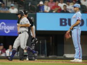 Seattle Mariners's Abraham Toro, left, scores in front of Texas Rangers pitcher Brock Burke, right, after a wild pitch during the 10th inning of a baseball game in Arlington, Texas, Sunday, June 5, 2022.