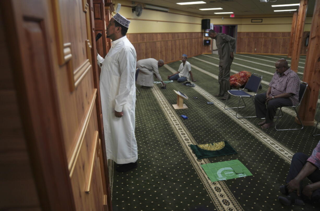 A member of the Abubakar As-Saddique Islamic Center recites the Islamic call to prayer, or adhan, on Thursday, May 12, 2022, in Minneapolis. The adhan exhorts men to go to the closest mosque five times a day for prayer, which is one of the Five Pillars of Islam. Abubakar, which hosts some 1,000 men for Friday midday prayers, plans to hold meetings with neighbors before publicly broadcasting publicly the call this summer.