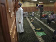 A member of the Abubakar As-Saddique Islamic Center recites the Islamic call to prayer, or adhan, on Thursday, May 12, 2022, in Minneapolis. The adhan exhorts men to go to the closest mosque five times a day for prayer, which is one of the Five Pillars of Islam. Abubakar, which hosts some 1,000 men for Friday midday prayers, plans to hold meetings with neighbors before publicly broadcasting publicly the call this summer.