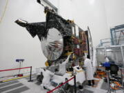 FILE - Technicians work on the Psyche spacecraft at the NASA Jet Propulsion Laboratory, April 11, 2022, in Pasadena, Calif. NASA put an asteroid mission on hold Friday, June 24, 2022, blaming the late delivery of its own navigation software. The Psyche mission to a strange metal asteroid of the same name was supposed to launch this September or October. But the agency's Jet Propulsion Lab was several months late writing and delivering its software for navigation, guidance and control.