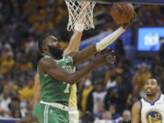 Boston Celtics guard Jaylen Brown (7) shoots against the Golden State Warriors during the second half of Game 1 of basketball's NBA Finals in San Francisco, Thursday, June 2, 2022.