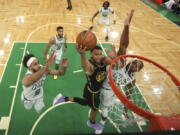 Golden State Warriors guard Stephen Curry (30) goes up for a shot against Boston Celtics center Al Horford (42) and guard Derrick White (9) during Game 4 of basketball's NBA Finals, Friday, June 10, 2022, in Boston.