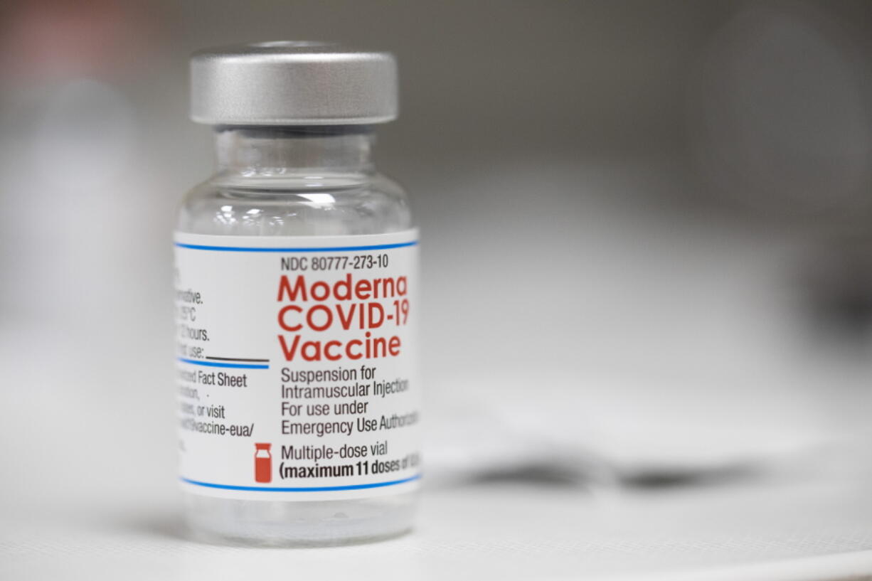 FILE- A vial of the Moderna COVID-19 vaccine is displayed on a counter at a pharmacy in Portland, Ore., on, Dec. 27, 2021.