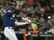 Seattle Mariners' Jessie Winker hits a two-run double off Baltimore Orioles relief pitcher Felix Bautista during the eighth inning of a baseball game Tuesday, June 28, 2022, in Seattle.