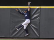 Seattle Mariners centerfielder Julio Rodriguez hits the outfield wall after failing to catch a home run ball hit by Baltimore Orioles' Jorge Mateo during the sixth inning of a baseball game, Monday, June 27, 2022, in Seattle.