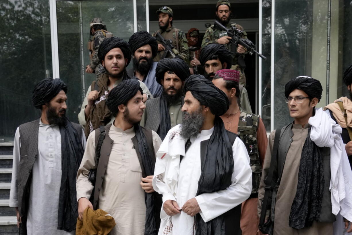 FILE - Mullah Abdul Ghani Baradar, acting deputy prime minister of the Afghan Taliban's caretaker government, center, and other Taliban officials attend a ceremony marking the 9th anniversary of the death of Mullah Mohammad Omar, the late leader and founder of the Taliban, in Kabul, Afghanistan, April 24, 2022. The Pakistani Taliban said Wednesday May 18, 2022, that they are extending a cease-fire with the government in Islamabad until May 30, after the two sides held an initial round of talks in neighboring Afghanistan. The militant group, known as Tehrik-e-Taliban Pakistan or TTP, said in a statement on Wednesday that the talks were facilitated by Afghanistan's new Taliban rulers.