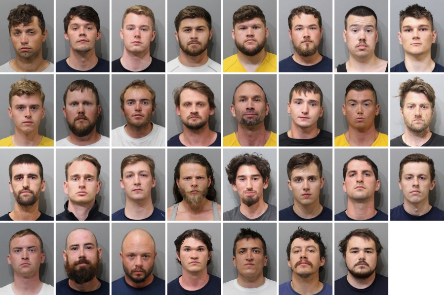 These booking images provided by the Kootenai County Sheriff'??s Office show the 31 members of the white supremacist group Patriot Front who were arrested after they were found packed into the back of a U-Haul truck with riot gear near an LGBTQ pride event in Coeur d'??Alene, Idaho, on Saturday, June 11, 2022. Top row, from left, are Jared Boyce, Nathan Brenner, Colton Brown, Josiah Buster, Mishael Buster, Devin Center, Dylan Corio, and Winston Durham. Second row, from left, are Garret Garland, Branden Haney, Richard Jessop, James Julius Johnson, James Michael Johnson, Connor Moran, Kieran Morris and Lawrence Norman. Third row, from left, are Justin O'leary, Cameron Pruitt, Forrest Rankin, Thomas Rousseau, Conor Ryan, Spencer Simpson, Alexander Sisenstein and Derek Smith. Bottom row, from left, are Dakota Tabler, Steven Tucker, Wesley Van Horn, Mitchell Wagner, Nathaniel Whitfield, Graham Whitsom and Robert Whitted.