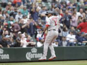 Boston Red Sox's Rafael Devers celebrates as he runs home after hitting a two-run home run on a pitch from Seattle Mariners' Paul Sewald during the eighth inning of a baseball game, Sunday, June 12, 2022, in Seattle.