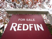 FILE - A Redfin "for sale" sign stands in front of a house on Oct. 28, 2020, in Seattle.