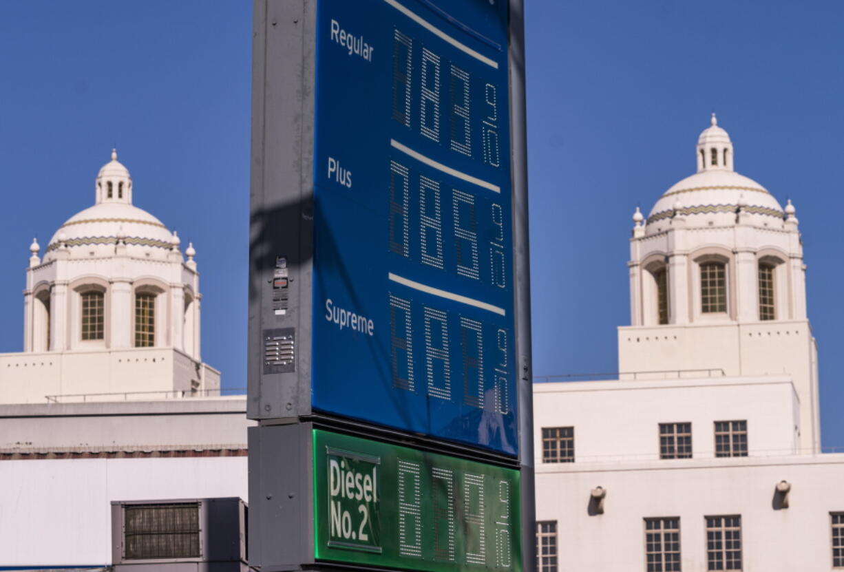 FILE - Various grades of gasoline, with prices above seven dollars per gallon, are displayed at a Chevron gas station, May 22, 2022, in downtown Los Angeles. Americans cut their spending unexpectedly in May compared with the month before, underscoring how surging inflation on daily necessities like gas is causing them to be more cautious about buying discretionary items.