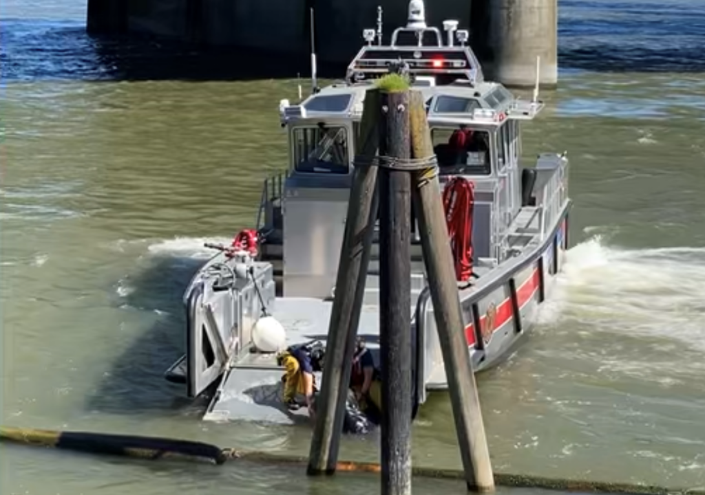 Crews from a Vancouver Fire Department fireboat rescue a man from the Columbia River on Monday afternoon.