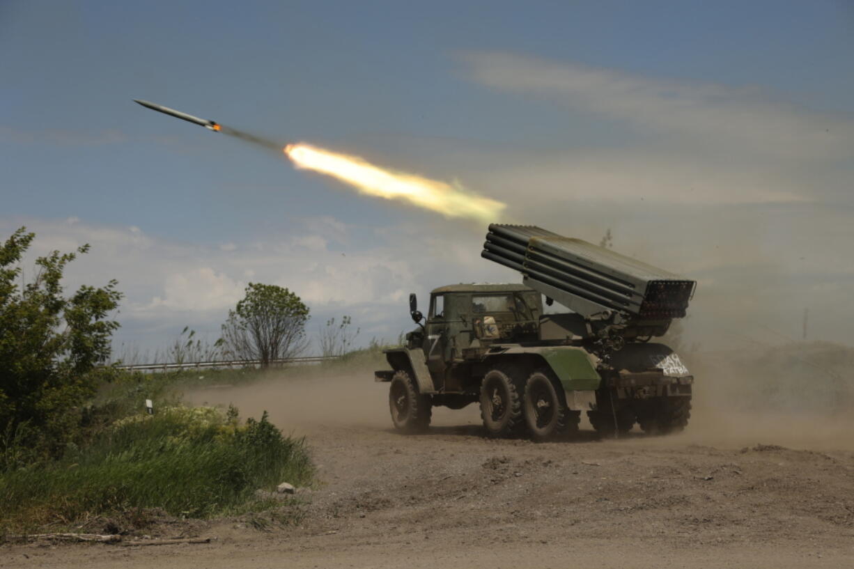 FILE - A Donetsk People's Republic militia's multiple rocket launcher fires from its position not far from Panteleimonivka, in territory under the government of the Donetsk People's Republic, eastern Ukraine, Saturday, May 28, 2022. Day after day, Russia is pounding the Donbas region of Ukraine with relentless artillery and air raids, making slow but steady progress to seize the industrial heartland of its neighbor. With the conflict now in its fourth month, it's a high-stakes campaign that could dictate the course of the entire war.