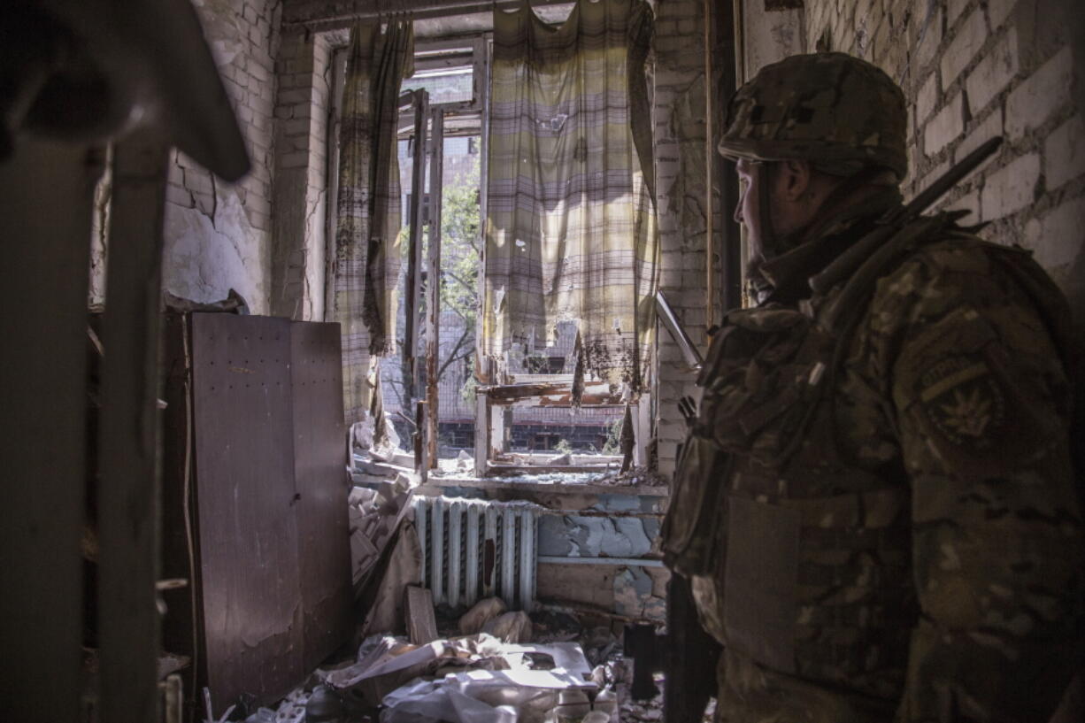 A Ukrainian soldier stands in a position during heavy fighting on the front line in Severodonetsk, the Luhansk region, Ukraine, Wednesday, June 8, 2022.