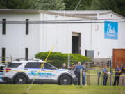 Law enforcement officials stand near the scene of a shooting Thursday at Columbia Machine Inc., in Smithsburg, Md.