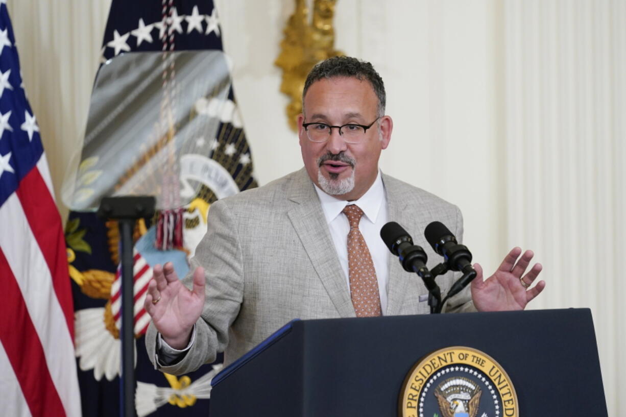 FILE - Education Secretary Miguel Cardona speaks during the 2022 National and State Teachers of the Year event in the East Room of the White House in Washington, April 27, 2022. The Biden administration says it will forgive all remaining federal student debt for former students of the for-profit Corinthian Colleges chain. "As of today, every student deceived, defrauded and driven into debt by Corinthian Colleges can rest assured that the Biden-Harris Administration has their back and will discharge their federal student loans," Cardona said.