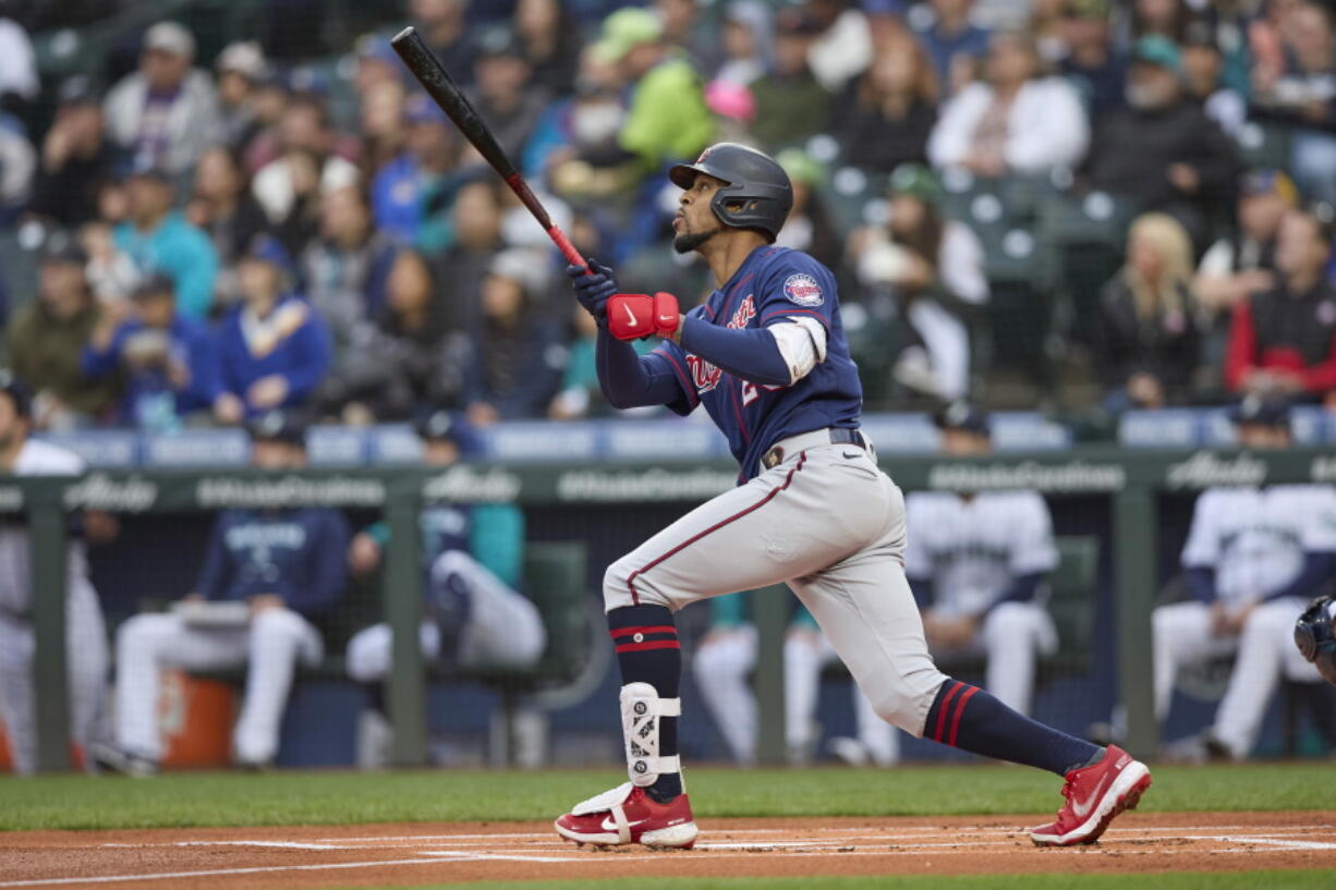 Minnesota Twins' Byron Buxton hits a two-run home run off a pitch from Seattle Mariners starter Chris Flexen during the first inning of a baseball game, Monday, June 13, 2022, in Seattle.