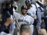 Seattle Mariners' Eugenio Suarez celebrates after hitting a two-run home run off Minnesota Twins starting pitcher Joe Ryan during the fourth inning of a baseball game Tuesday, June 14, 2022, in Seattle.