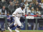 Seattle Mariners' Taylor Trammell hits a solo home run on a pitch from Minnesota Twins' Jharel Cotton during the seventh inning of a baseball game, Monday, June 13, 2022, in Seattle.