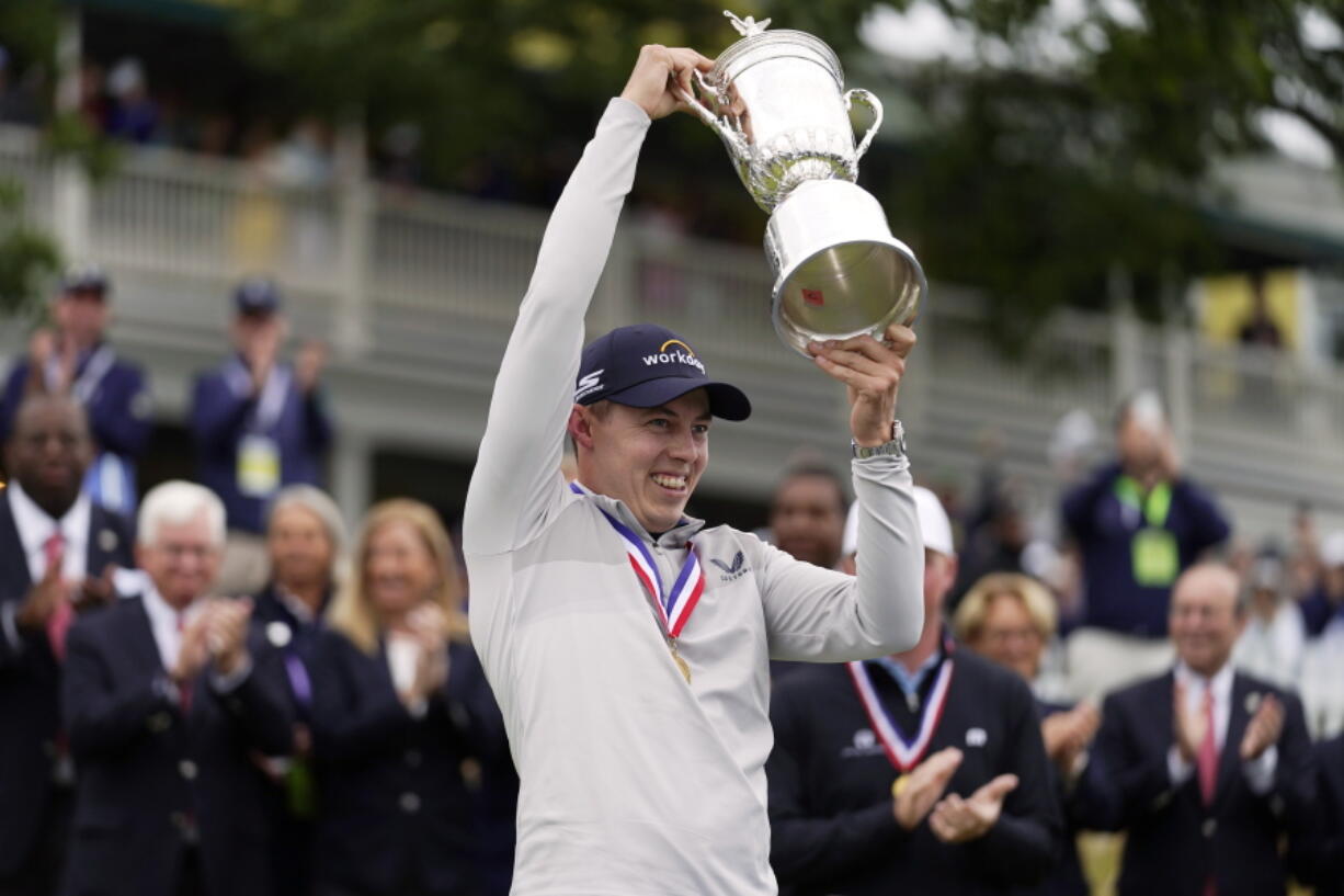 Matthew Fitzpatrick, of England, celebrates with the trophy after winning the U.S. Open golf tournament at The Country Club, Sunday, June 19, 2022, in Brookline, Mass.