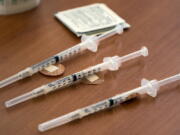 FILE - Doses of the Moderna COVID-19 vaccine wait to be administered during a vaccination clinic in Odessa, Texas, on Tuesday, Aug. 24, 2021. On Thursday, June 23, 2022, an expert panel is recommending Moderna's COVID-19 shots for kids ages 6 to 17, marking another step toward bringing a second brand of vaccine for kids in that age group.