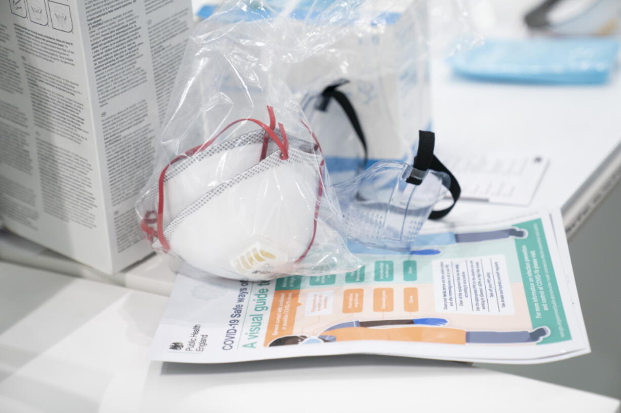 FILE - In this Thursday, April 16, 2020 photo, a view of masks and goggles, part of PPE, personal protective equipment, to avoid being infected or transmitting coronavirus, at the Nightingale Hospital North West set up in the Manchester Central Convention Complex in Manchester, northern England. The British government plans to burn billions of pounds (dollars) in unusable protective equipment purchased at haste during the coronavirus pandemic to generate power, a public spending watchdog said Friday, June 10, 2022.