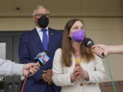 Washington Gov. Jay Inslee, left, wears a mask as he talks to reporters along with Washington State Dept. of Ecology Director Laura Watson, right, Thursday, June 2, 2022, outside a Dept. of Ecology office in Richland, Wash. Inslee, who has recently criticized the slow pace of cleaning up the Hanford Nuclear Reservation in Washington state, was speaking ahead of a scheduled tour of the nuclear weapons production site and repeated his message that more federal money is needed to finish the job. (AP Photo/Ted S.