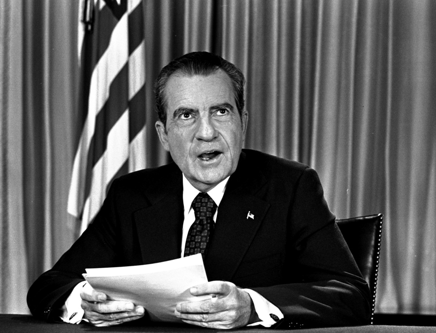 FILE - President Nixon sits in his White House office on Aug. 16, 1973, as he poses for photographer after delivering a nationwide television address dealing with Watergate. Nixon repeated that he had no prior knowledge of the Watergate break-in and was not aware of any cover-up.