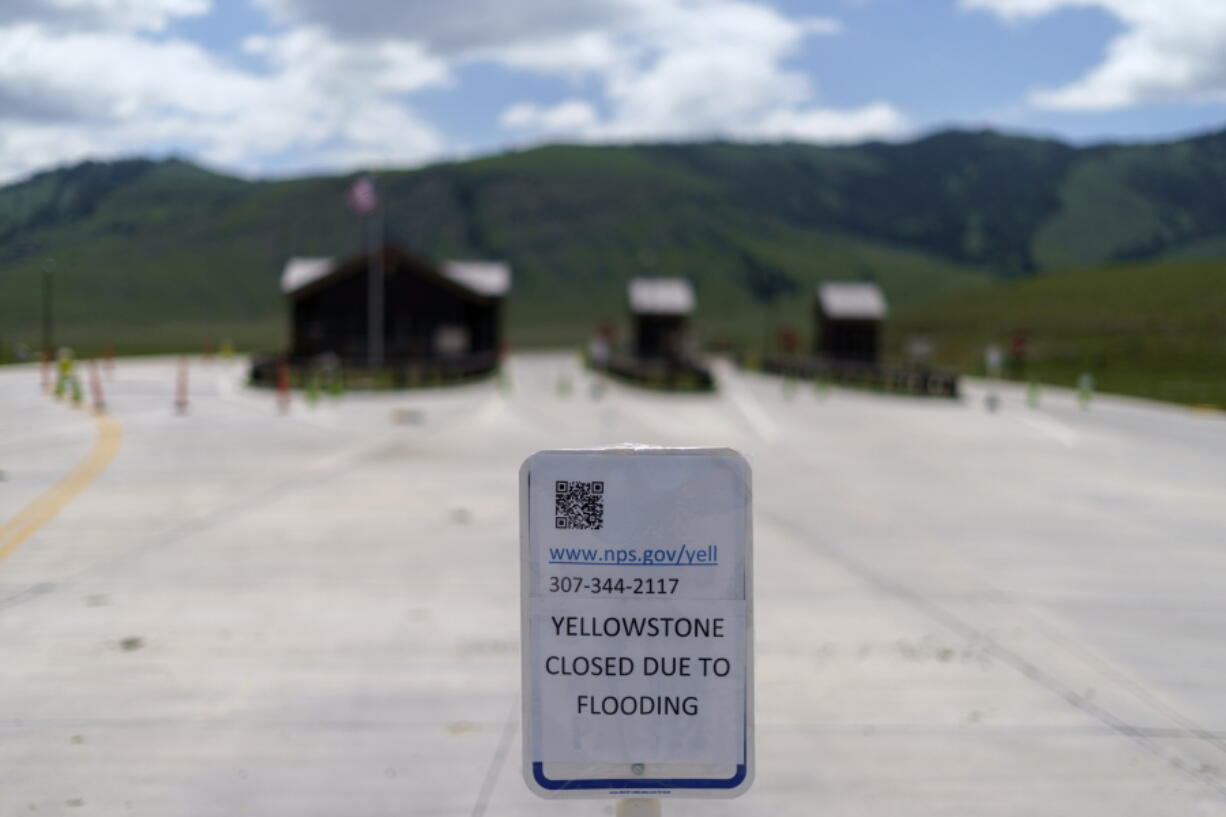 FILE - The entrance to Yellowstone National Park, a major tourist attraction, sits closed due to the historic floodwaters on June 15, 2022, in Gardiner, Mont.