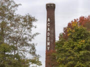 Fall colors frame the Providence Academy smokestack last October. It is set to be demolished in August.