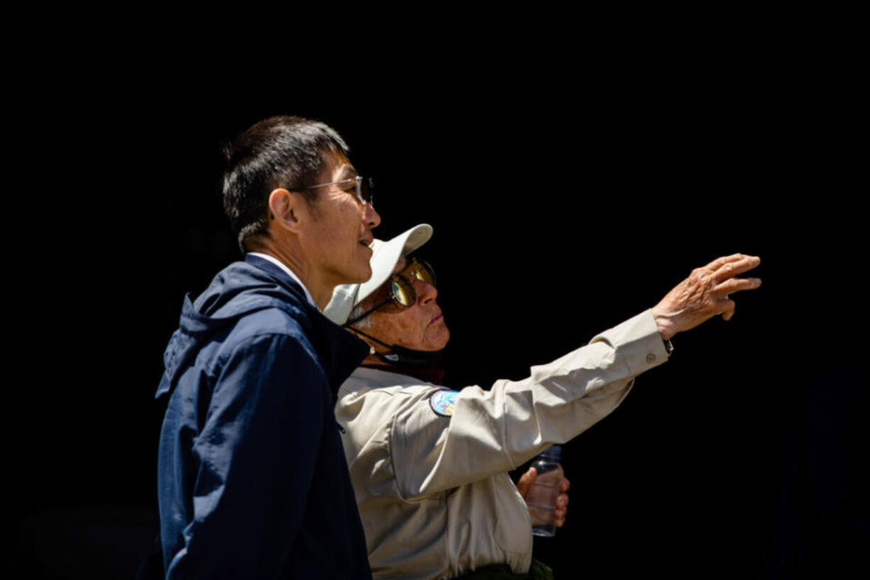 Park ranger Annemarie Randall, right, speaks with a visitor near the Paradise Visitor Center at Mount Rainier National Park.