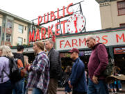 Visitors walk around Pike Place Market on Friday, June 17, 2022. On Friday, three cruise ships docked in Elliot Bay, sending a wave of tourists to the market.