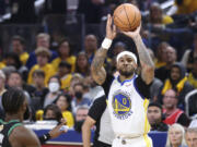 Golden State Warriors guard Gary Payton II (0) shoots against the Boston Celtics during the first half of Game 5 of basketball's NBA Finals in San Francisco, Monday, June 13, 2022.