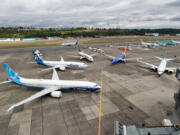 An Icelandair 737 taxis past the 737 MAX family of airplanes outside Boeing's Seattle Delivery Center at Boeing Field in July.