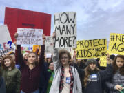 FILE- This March 14, 2018 file photos shows students at Roosevelt High School taking part in a protest against gun violence in Seattle. In the wake of a Valentine's Day shooting that killed 17, a handful of Parkland, Fla., teenagers are on the cusp of pulling off what could be one of the largest marches in history with nearly 1 million expected in DC and more than 800 sister marches planned across every continent.