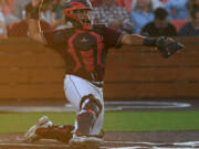 Raptors catcher Isaac Lovings throws the ball Friday, June 24, 2022, during a game between Ridgefield and the Victoria HarbourCats at the Ridgefield Outdoor Recreation Complex.