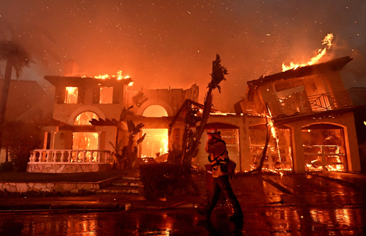 Firefighters battle a brush fire at Coronado Pointe in Laguna Niguel, California, on Wednesday, May 11, 2022.