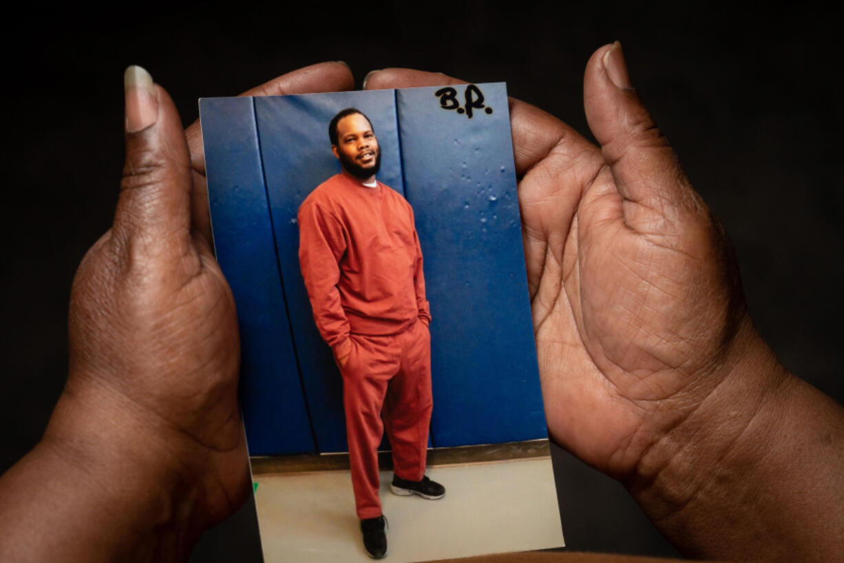 Theresa Westman holds a photo of her son Rasheem Hall, who's serving life in prison for a murder that the prosecution witnesses maintain he had no role in.