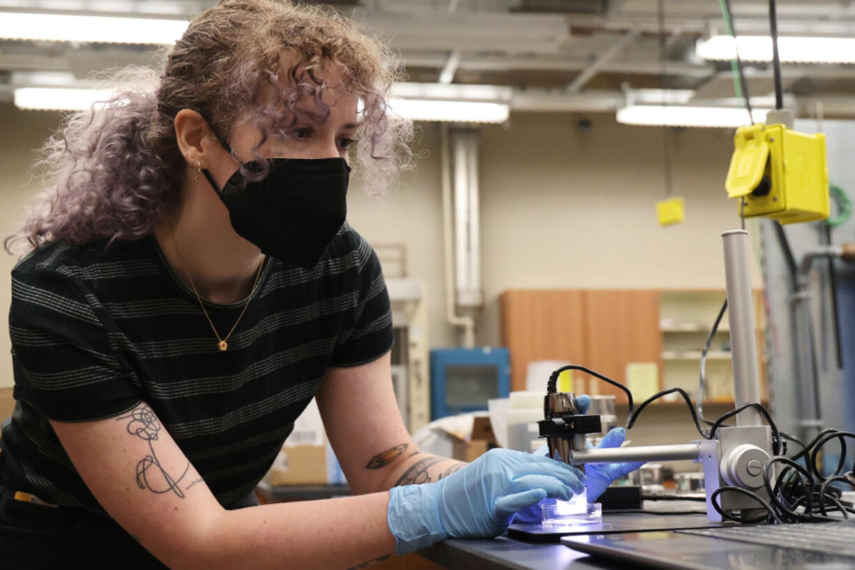 University of Central Florida physics graduate student Autumn Shackelford demonstrates Lunar Mare simulant at a lab in the UCF Physical Sciences Building on May 16.