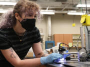 University of Central Florida physics graduate student Autumn Shackelford demonstrates Lunar Mare simulant at a lab in the UCF Physical Sciences Building on May 16.