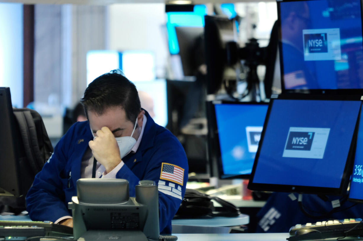 Traders work on the floor during a steep dip of the New York Stock Exchange on May 18, 2022, in New York.