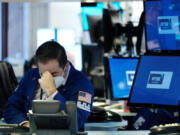 Traders work on the floor during a steep dip of the New York Stock Exchange on May 18, 2022, in New York.