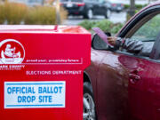 A voter drops off his ballot at a Clark County ballot drop box in the Vancouver Mall parking lot Nov. 3, 2020.